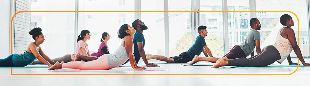 people doing yoga in a gym