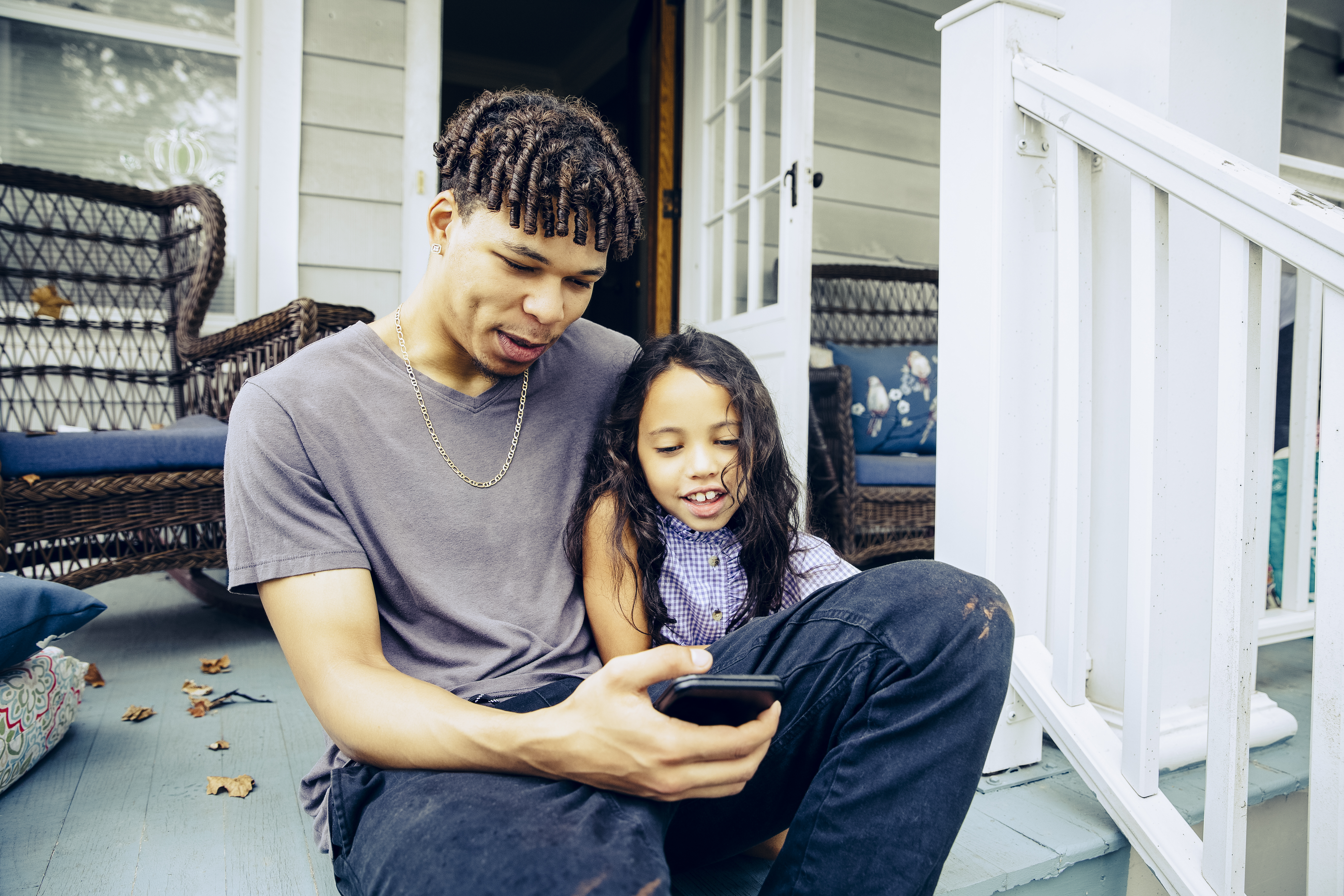 dad and daughter looking at phone